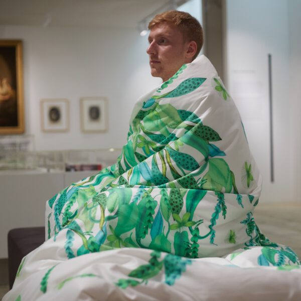 man in green and white duvet